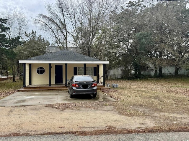 view of front of home with a porch and roof with shingles