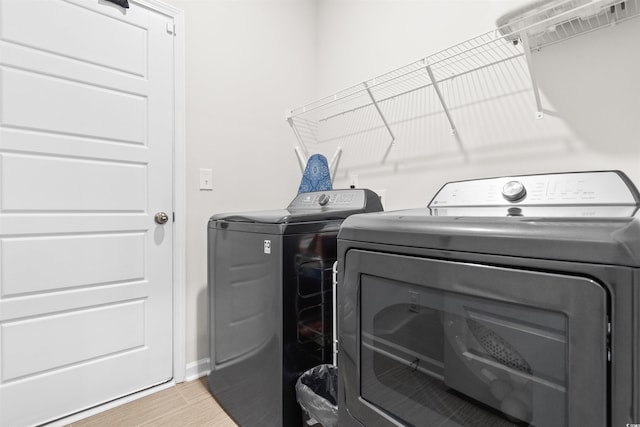 242 Timber Oaks Dr, Myrtle Beach, SC 29588 - washroom featuring separate washer and dryer, light wood finished floors, and baseboards
