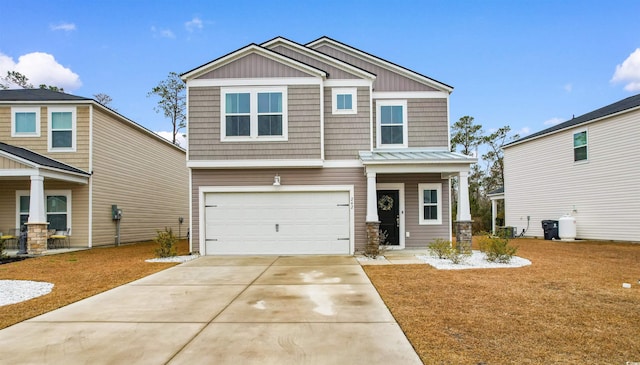 craftsman-style home with driveway, a garage, a standing seam roof, a front lawn, and board and batten siding