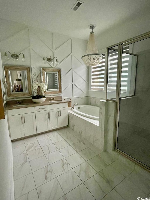 bathroom with vanity and shower with separate bathtub