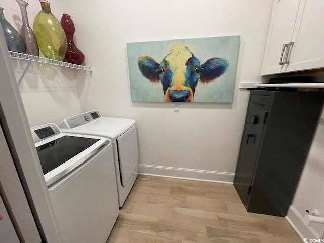 laundry area featuring cabinets, independent washer and dryer, and light wood-type flooring