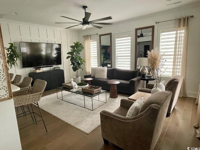 living room featuring hardwood / wood-style flooring, ornamental molding, a wealth of natural light, and ceiling fan