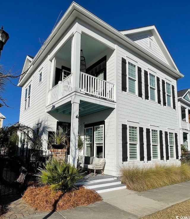 view of front of house featuring a balcony