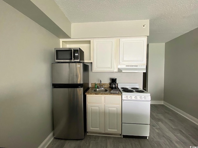 kitchen with stainless steel appliances, sink, white cabinets, and dark hardwood / wood-style flooring