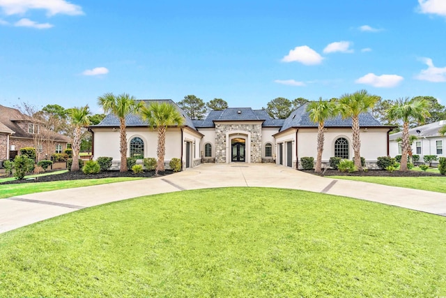 view of front of property with a front lawn and a garage