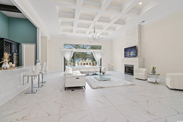 living room with coffered ceiling, beam ceiling, a notable chandelier, a towering ceiling, and a fireplace