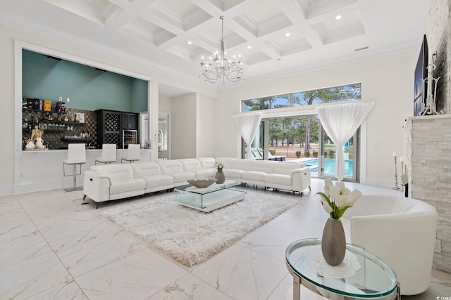 living room with beamed ceiling, a chandelier, a high ceiling, ornamental molding, and coffered ceiling