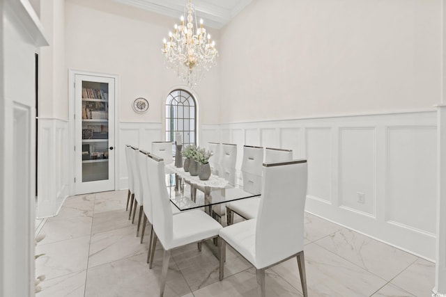 dining area with an inviting chandelier and crown molding