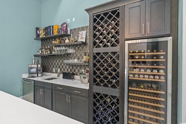 bar with sink, beverage cooler, and dishwasher