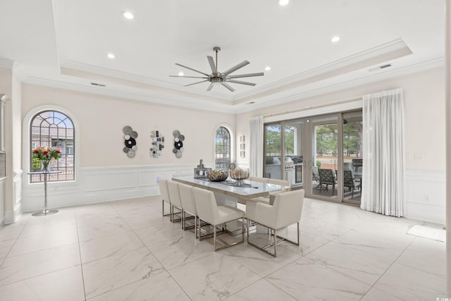 dining room with a tray ceiling, plenty of natural light, and french doors