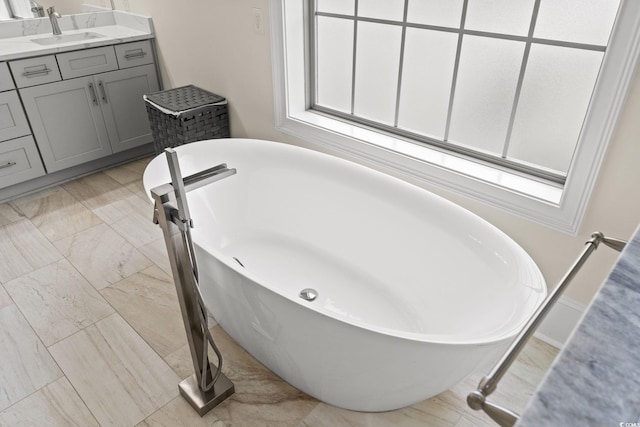 bathroom with vanity and a tub