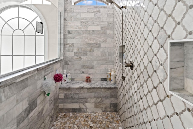 bathroom with a tile shower