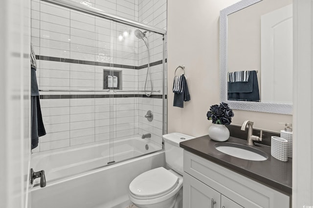 full bathroom with vanity, shower / bath combination with glass door, and toilet