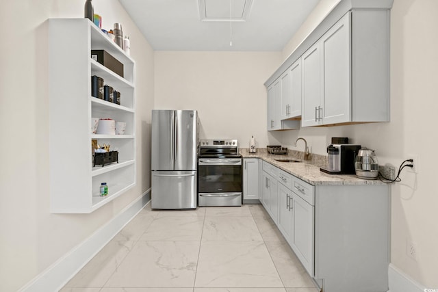 kitchen featuring sink, stainless steel appliances, and light stone countertops