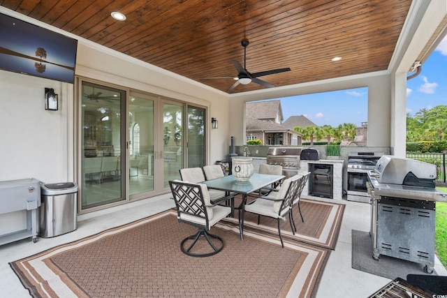 view of patio with ceiling fan, area for grilling, and grilling area