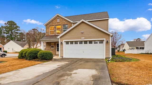 view of property featuring a garage and a front lawn