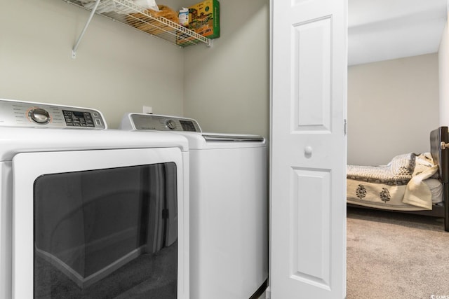 clothes washing area with light carpet and independent washer and dryer