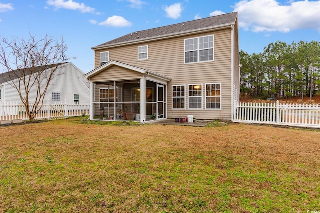 back of property with a yard and a sunroom