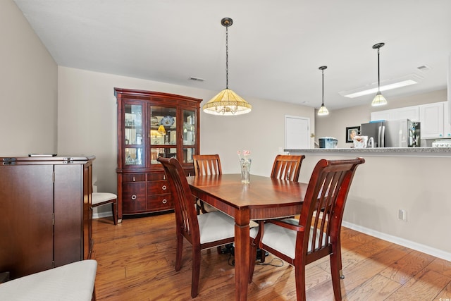 dining room with wood-type flooring