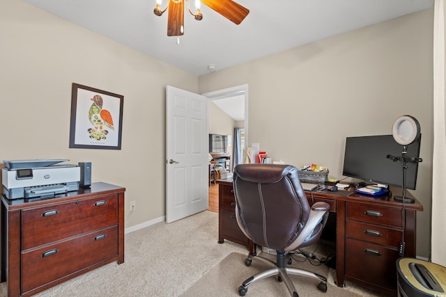 carpeted office space featuring ceiling fan