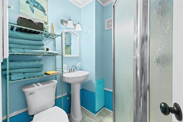 bathroom with crown molding, visible vents, a sink, and toilet