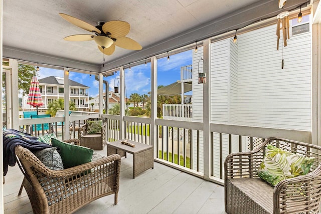 sunroom featuring a ceiling fan