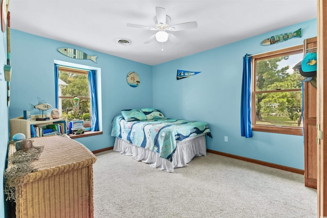 bedroom featuring a ceiling fan, carpet, visible vents, and baseboards