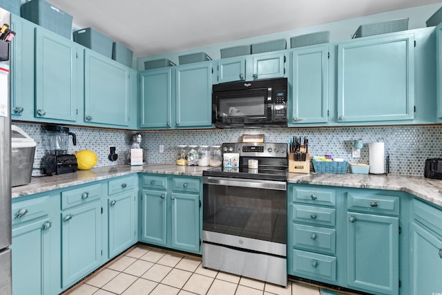 kitchen featuring decorative backsplash, stainless steel range with electric cooktop, blue cabinetry, black microwave, and light tile patterned flooring