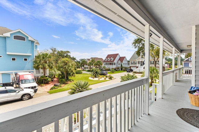 deck with a residential view and a porch