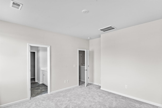unfurnished bedroom with baseboards, visible vents, and carpet flooring
