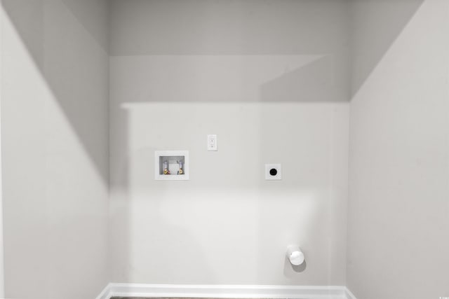 washroom featuring electric dryer hookup, baseboards, laundry area, and washer hookup