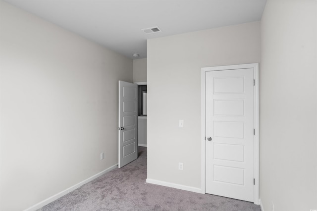 unfurnished bedroom featuring carpet flooring, baseboards, and visible vents