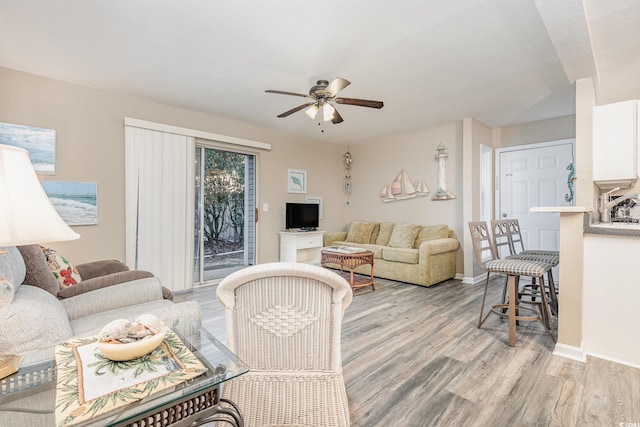 living room with ceiling fan and light wood-type flooring