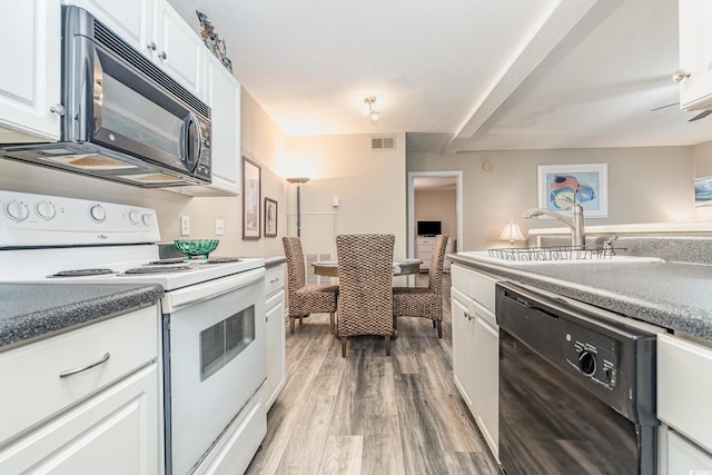 kitchen featuring white cabinetry, sink, hardwood / wood-style flooring, and black appliances