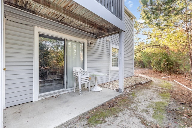 view of exterior entry featuring a patio area