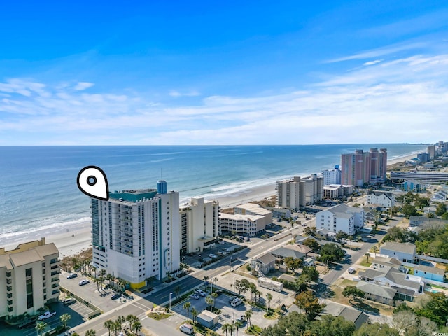 drone / aerial view with a view of city, a view of the beach, and a water view