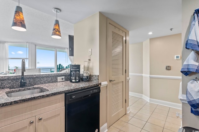 2301 S Ocean Blvd Unit 1401, North Myrtle Beach, SC 29582 - kitchen with black dishwasher, a sink, dark stone counters, light tile patterned floors, and decorative light fixtures