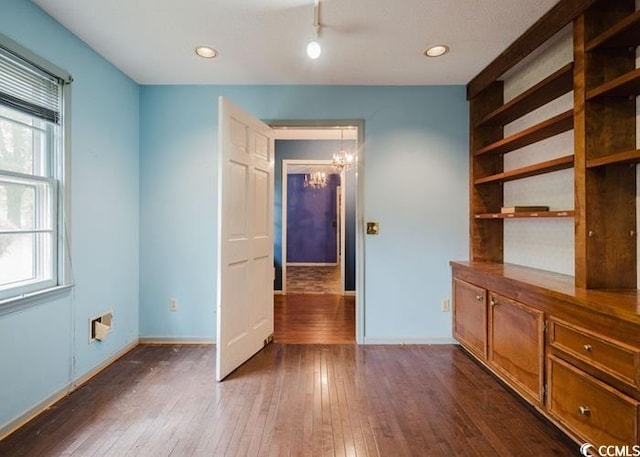 interior space with dark wood-style flooring, baseboards, an inviting chandelier, and recessed lighting