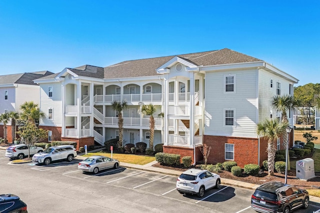 view of property with uncovered parking and a residential view