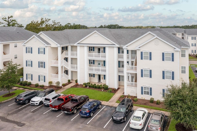 view of property featuring uncovered parking