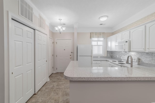 kitchen with white appliances, visible vents, a peninsula, light countertops, and white cabinets