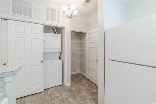 interior space featuring visible vents and stacked washer and clothes dryer