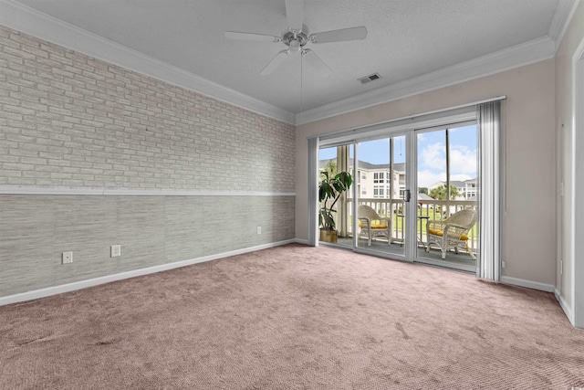 empty room with visible vents, baseboards, carpet, and ornamental molding