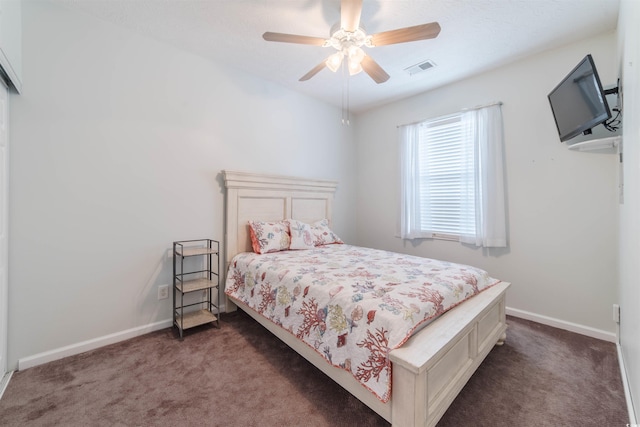 carpeted bedroom with visible vents, ceiling fan, and baseboards