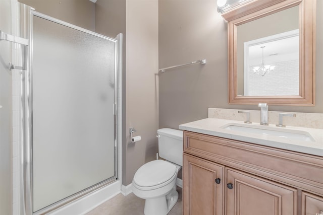 bathroom featuring a shower stall, toilet, vanity, and an inviting chandelier