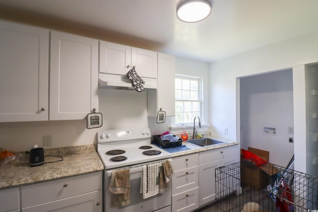 kitchen featuring under cabinet range hood, light countertops, white range with electric stovetop, white cabinetry, and a sink