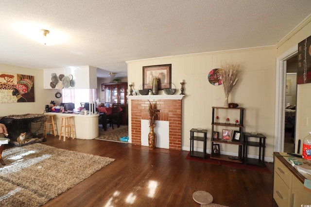 living room featuring wood finished floors, a fireplace, and a textured ceiling