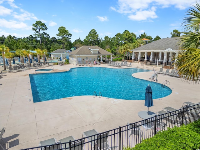 3000 Chesterwood Ct, Myrtle Beach, SC 29579 - community pool featuring a patio, a hot tub, and view of wooded area