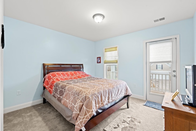 bedroom featuring light carpet, multiple windows, and access to outside