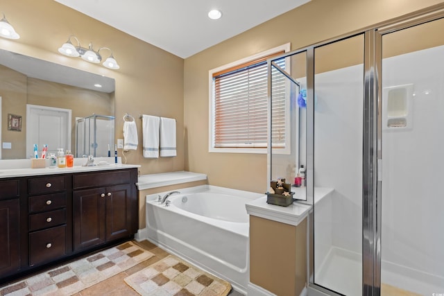 bathroom with independent shower and bath and vanity